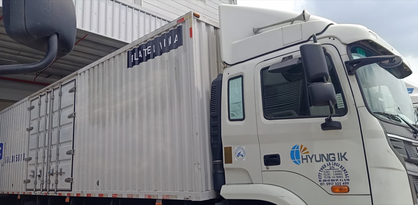 HYUNG IK branded truck at a loading bay